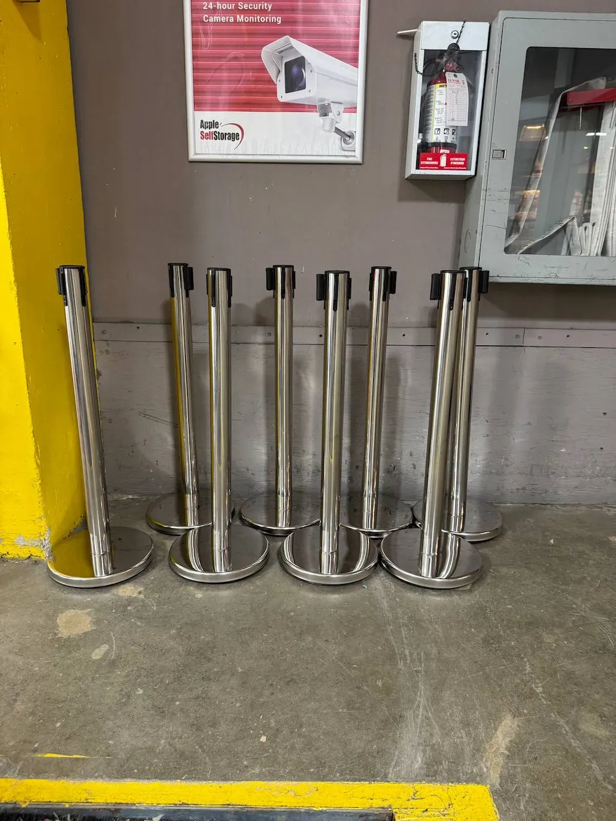 A row of polished chrome belt stanchion posts