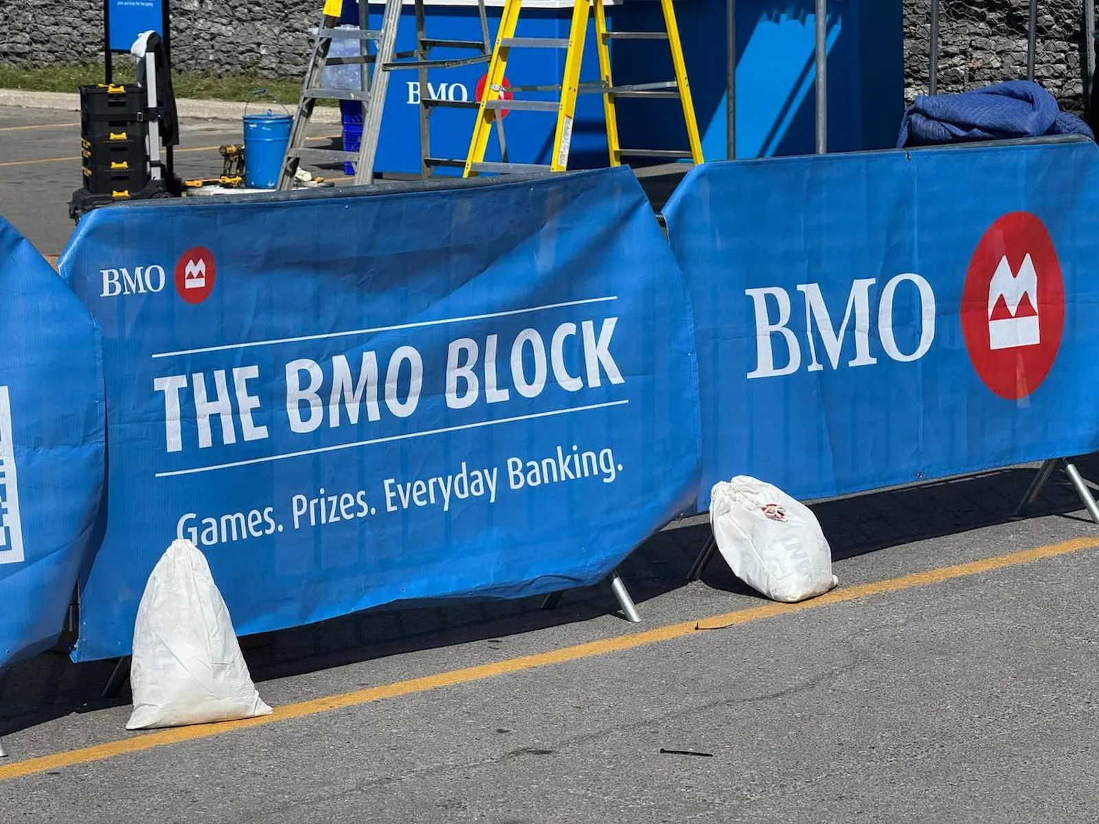 Crowd control barriers carrying branded scrims at an activation