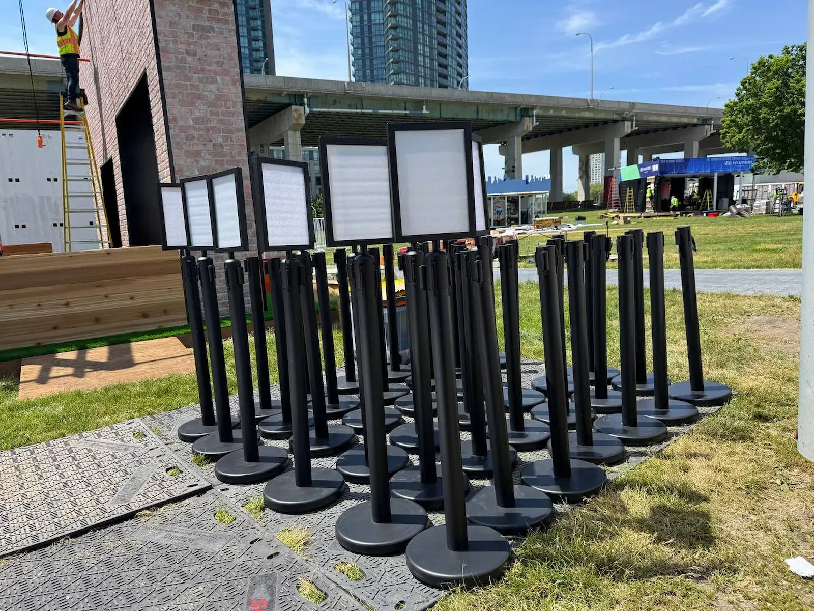 Belt stanchions carrying blank sign toppers during an event setup